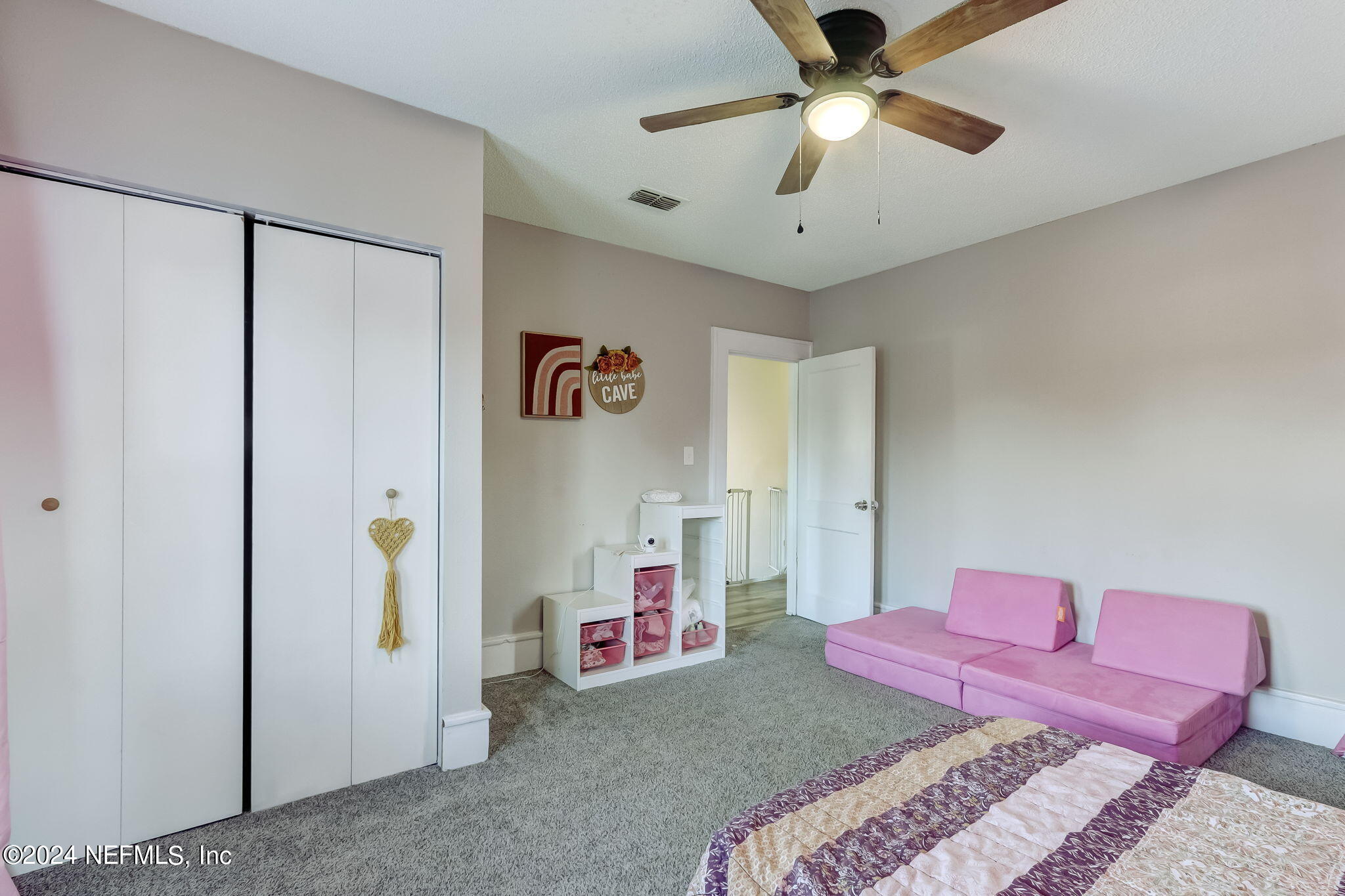 5316 Colonial Avenue Jacksonville, FL 32210 - Photo 24 of 30 a bedroom with a bed and a chandelier