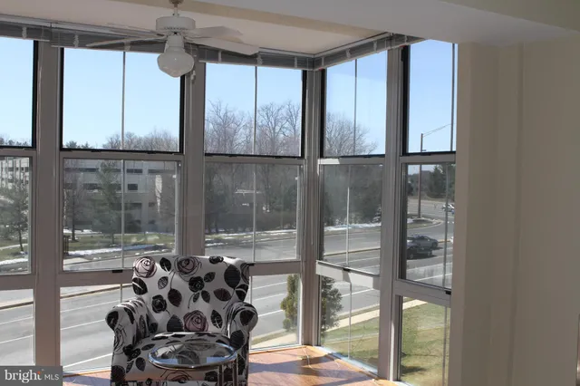 a glass door with glass top table and chairs