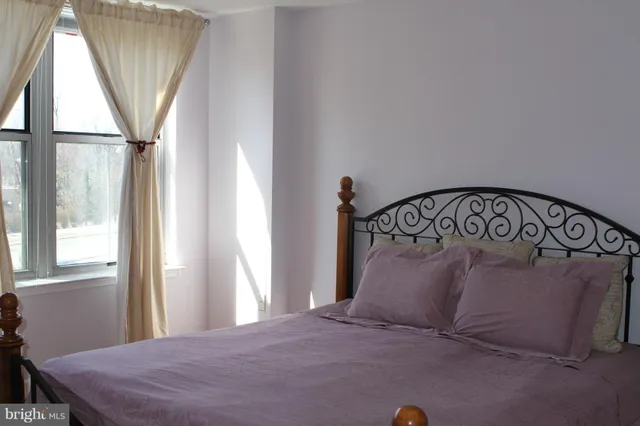 a bedroom with a bed and window