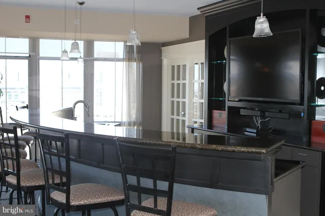 a kitchen with a table chairs and entryway