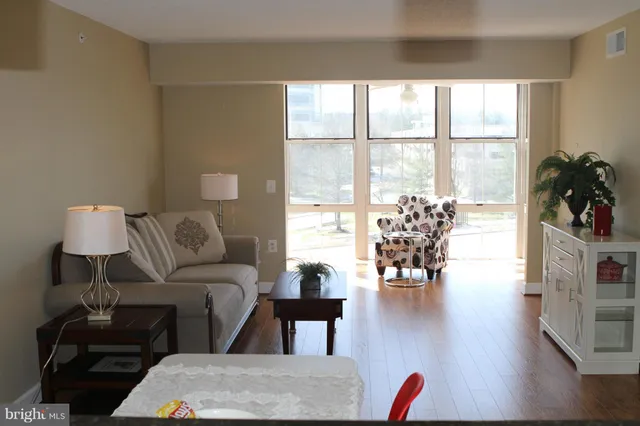 a living room with furniture and a large window