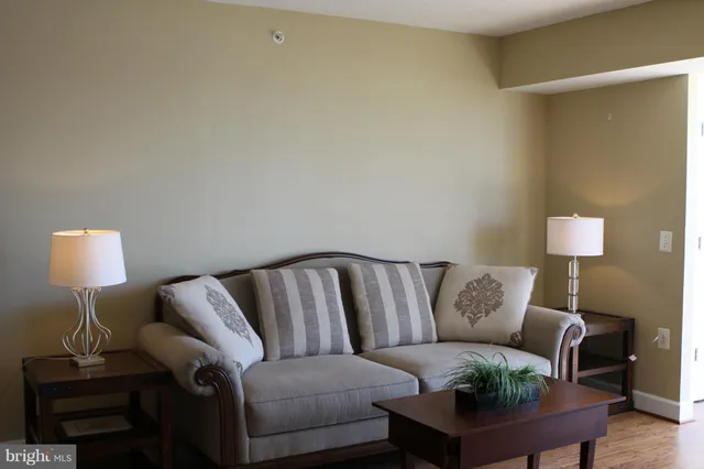 a living room with furniture and a lamp