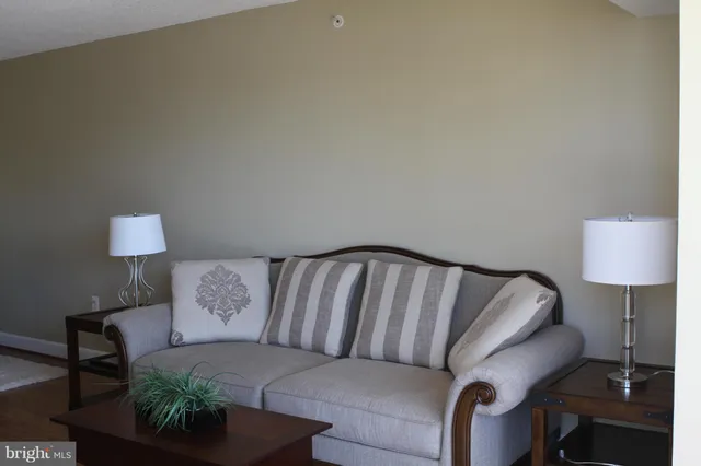 a living room with furniture and a lamp