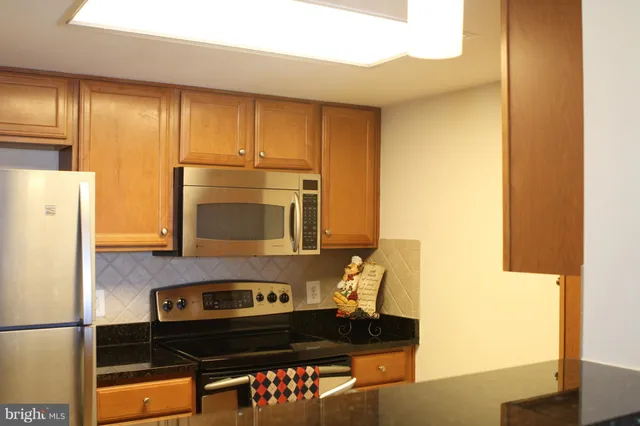 a kitchen with a sink and a refrigerator