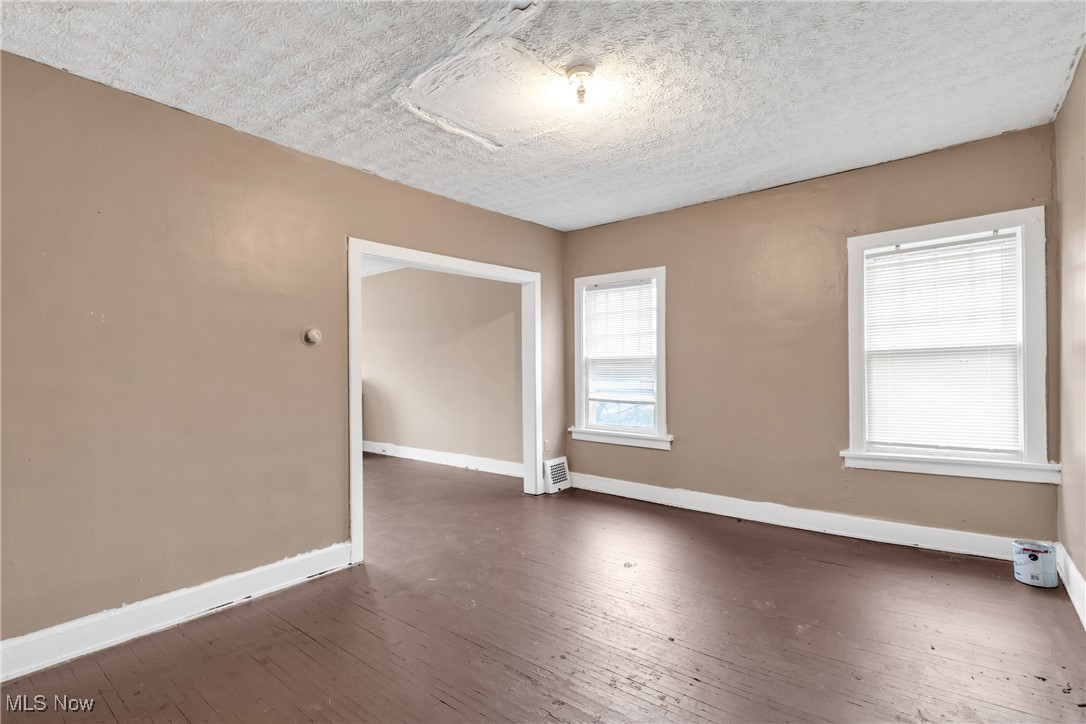 3770 Mayfield Road Cleveland Heights, OH 44121 - Photo 16 of 22 Empty room with dark wood-type flooring and a textured ceiling