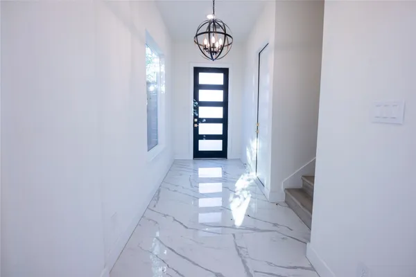 a view of an entryway with wooden floor