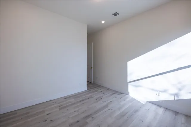 an empty room with wooden floor