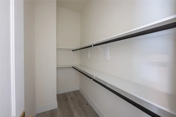 a bathroom with a granite countertop sink mirror vanity and toilet