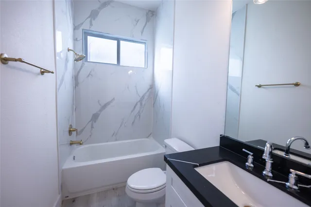 a bathroom with a sink a toilet and a bathtub