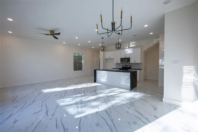 a view of a kitchen with a sink stainless steel appliances and cabinets