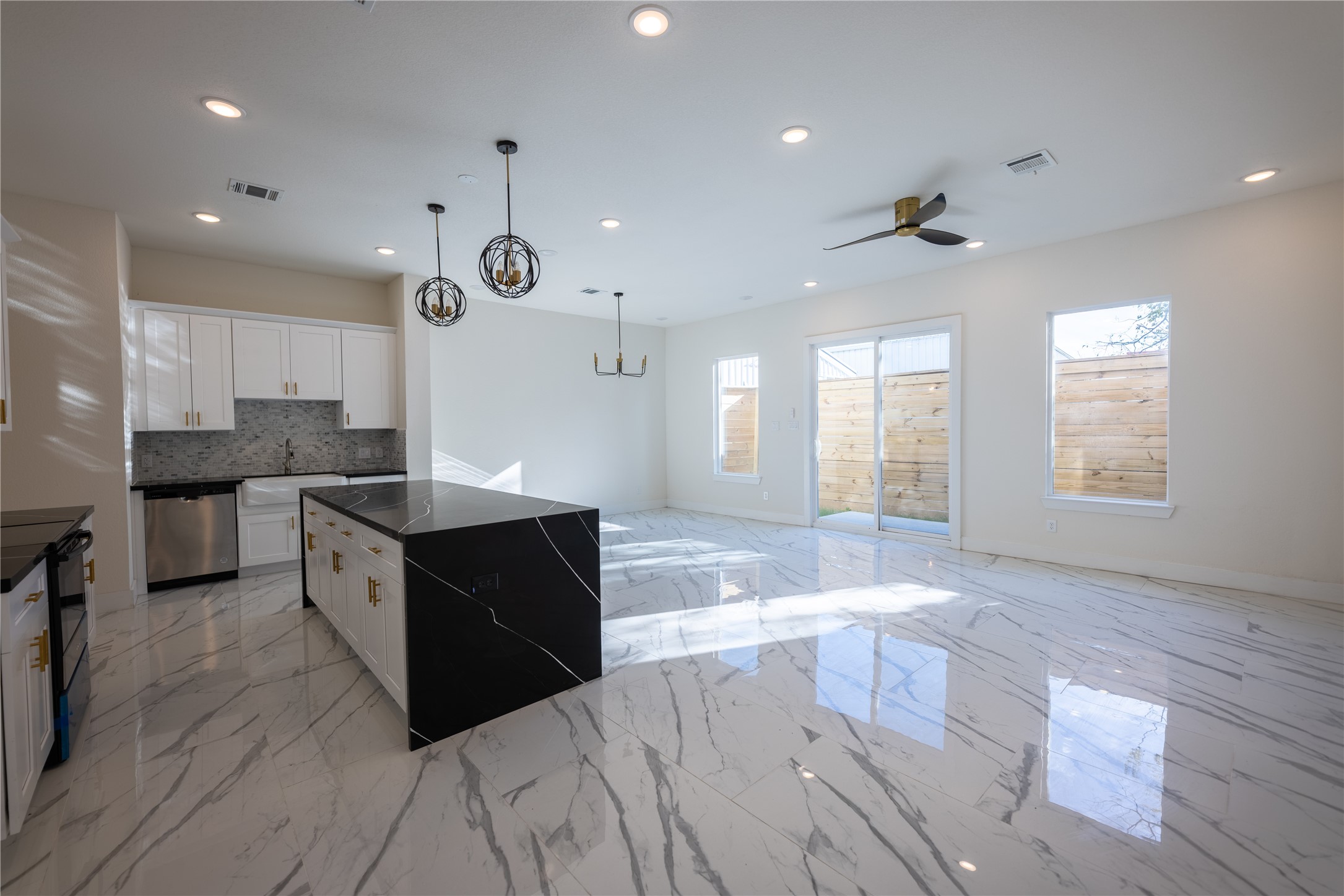 5906 St Augustine Street, Unit B Houston, TX 77021 - Photo 5 of 27 a large kitchen with stainless steel appliances kitchen island granite countertop a large counter top and wooden floors