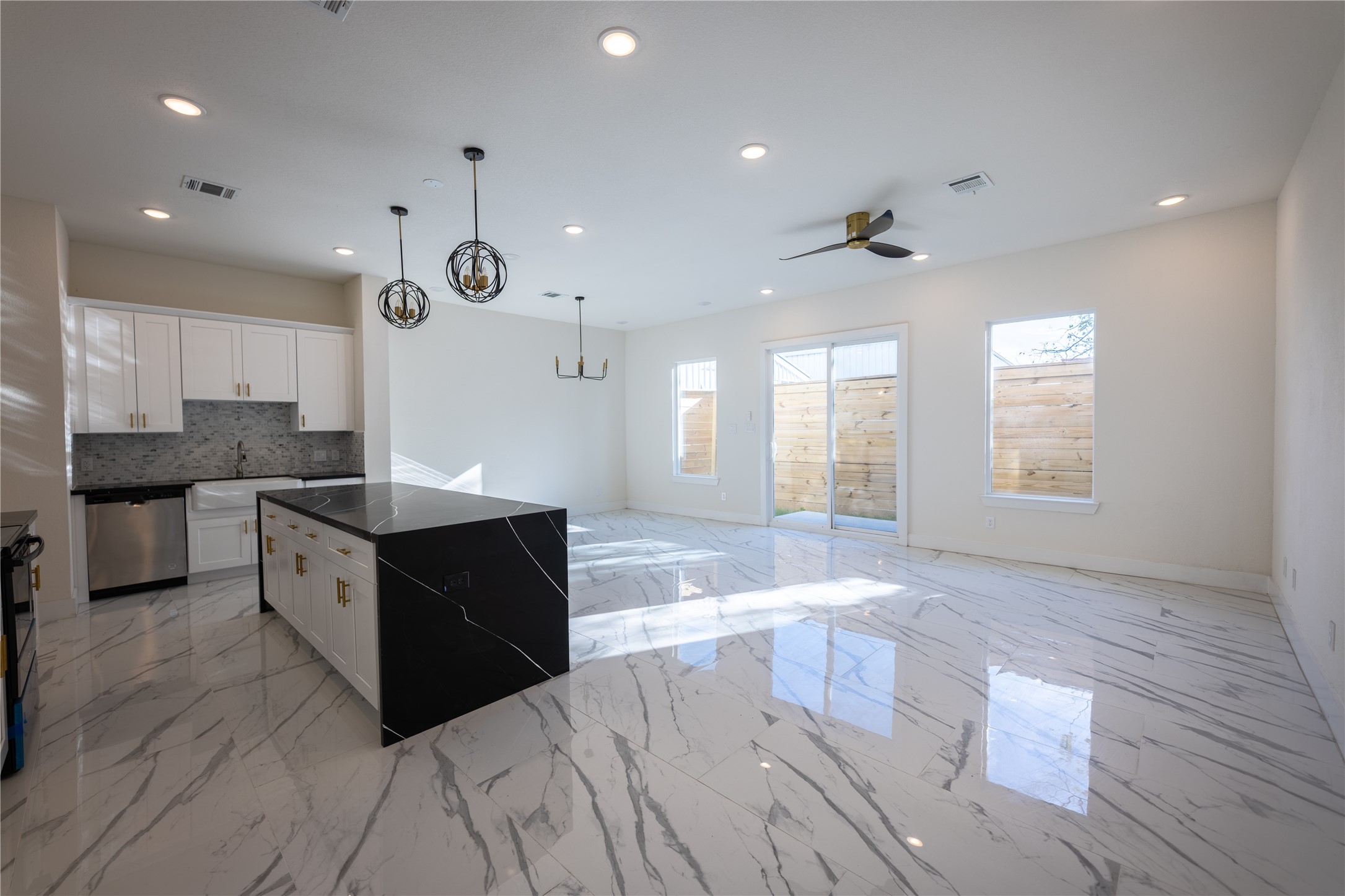 5906 St Augustine Street, Unit B Houston, TX 77021 - Photo 6 of 27 a large kitchen with stainless steel appliances kitchen island granite countertop a large counter top and a sink