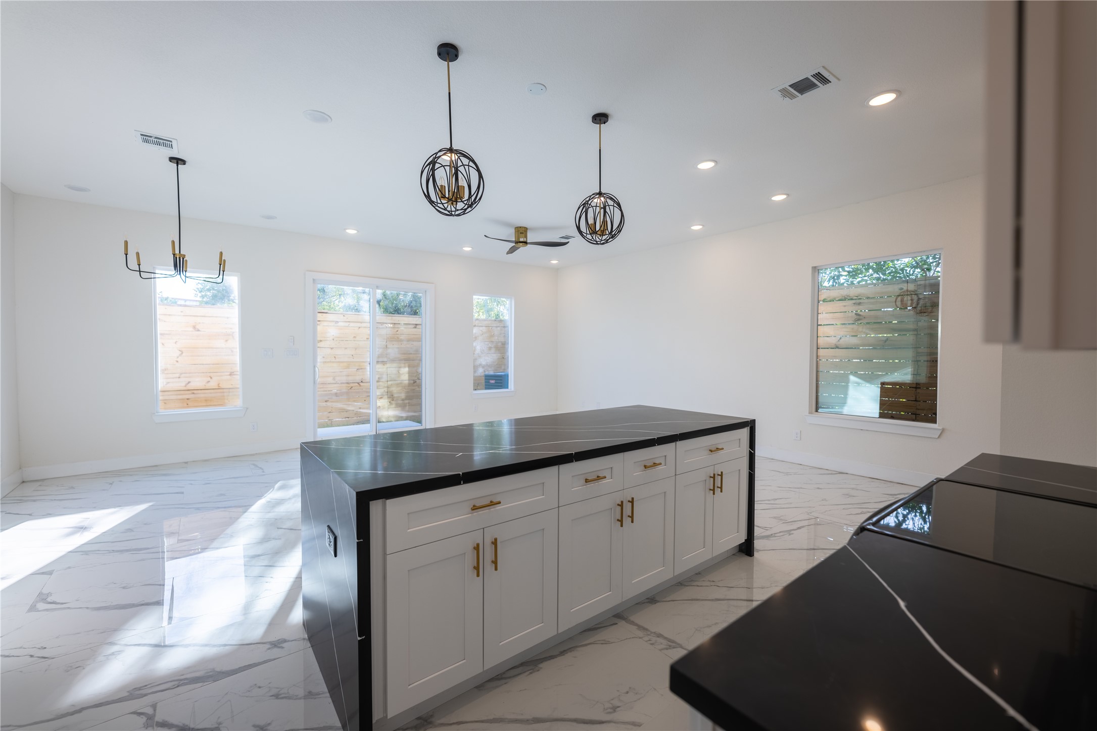 5906 St Augustine Street, Unit B Houston, TX 77021 - Photo 10 of 27 a kitchen with granite countertop cabinets a window and a sink