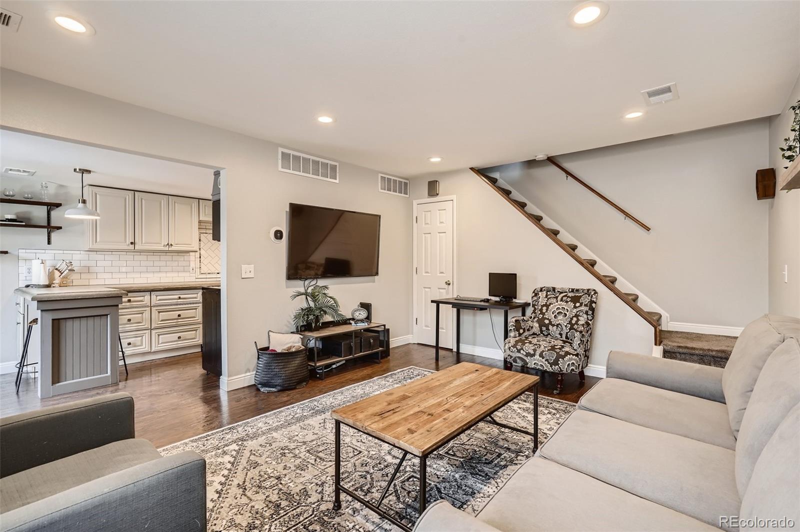 7972 Chase Circle, Unit 82 Arvada, CO 80003 - Photo 1 of 11 a living room with furniture and a flat screen tv