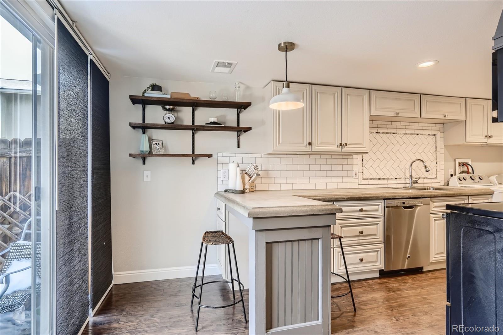 7972 Chase Circle, Unit 82 Arvada, CO 80003 - Photo 6 of 11 a kitchen with stainless steel appliances granite countertop a sink stove and cabinets
