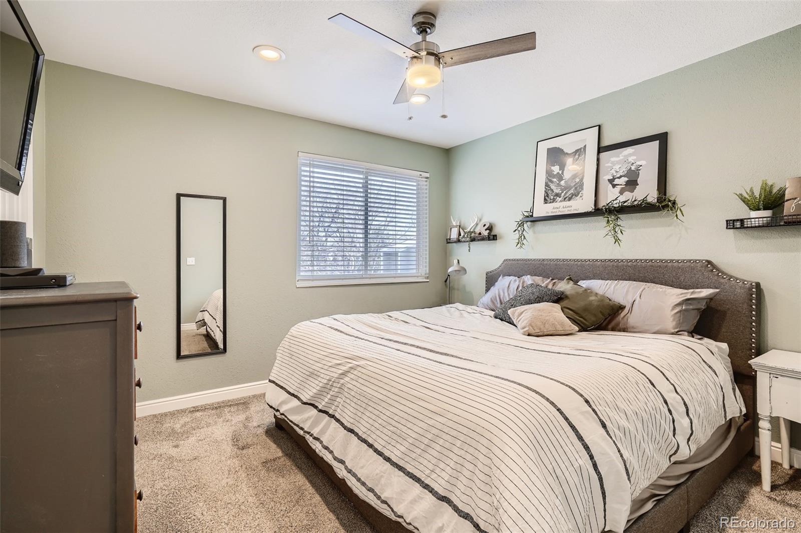 7972 Chase Circle, Unit 82 Arvada, CO 80003 - Photo 7 of 11 a bedroom with a large bed and a chandelier