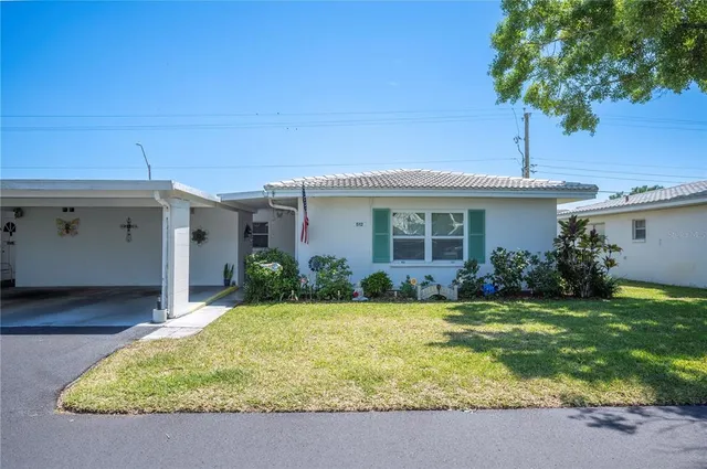 a view of a house with a yard and tree s