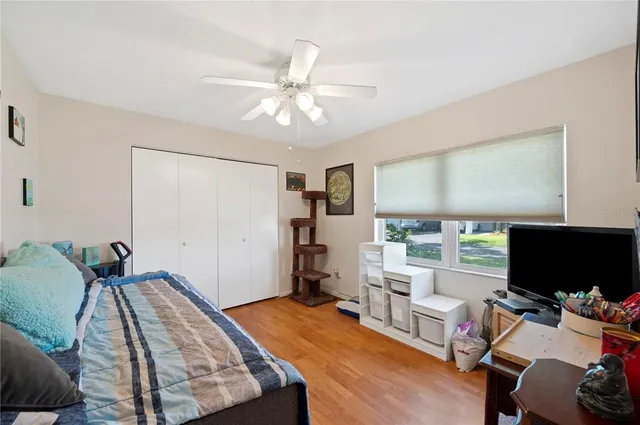 a bedroom with furniture and a flat screen tv