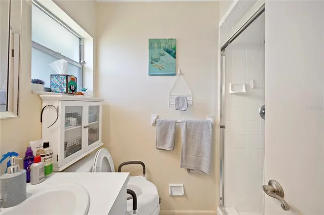 a bathroom with a tub sink and mirror