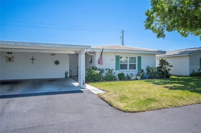 a view of a house with backyard and garden