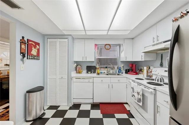a kitchen with stainless steel appliances a stove a sink and a refrigerator