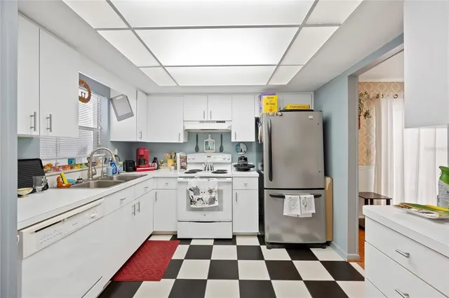a kitchen with stainless steel appliances granite countertop a refrigerator and sink
