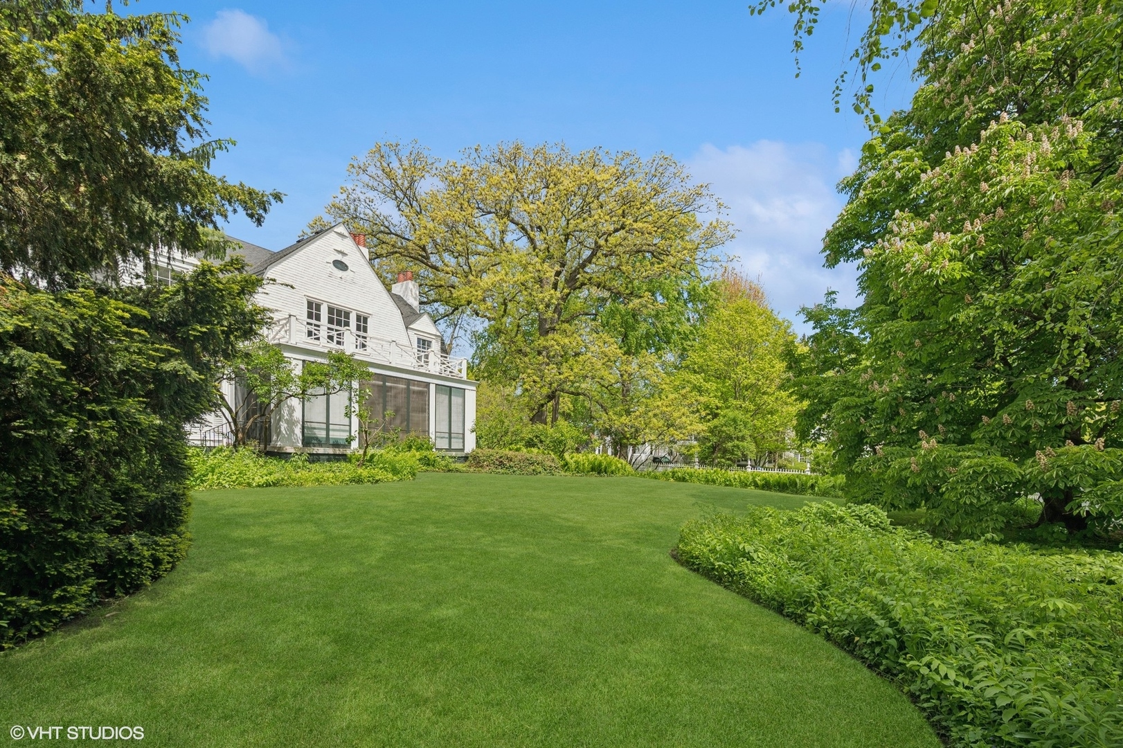 550 Oak Street Winnetka, IL 60093 - Photo 14 of 45 a front view of a house with a garden