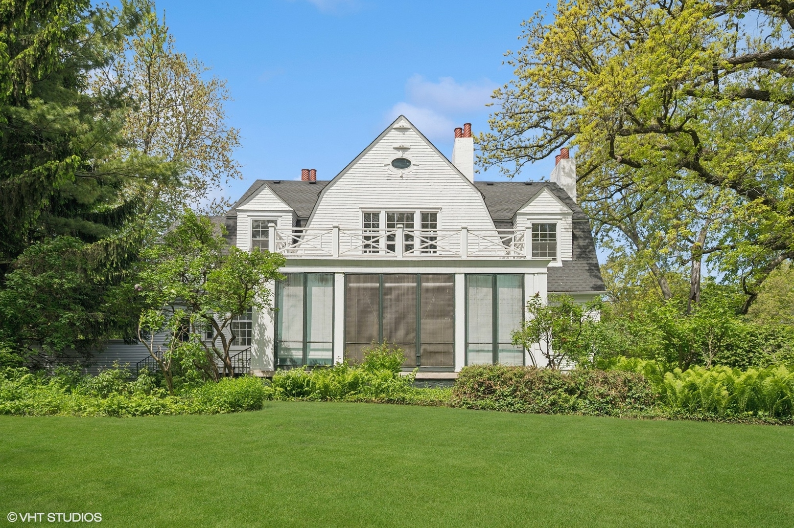 550 Oak Street Winnetka, IL 60093 - Photo 15 of 45 a front view of a house with a garden and plants