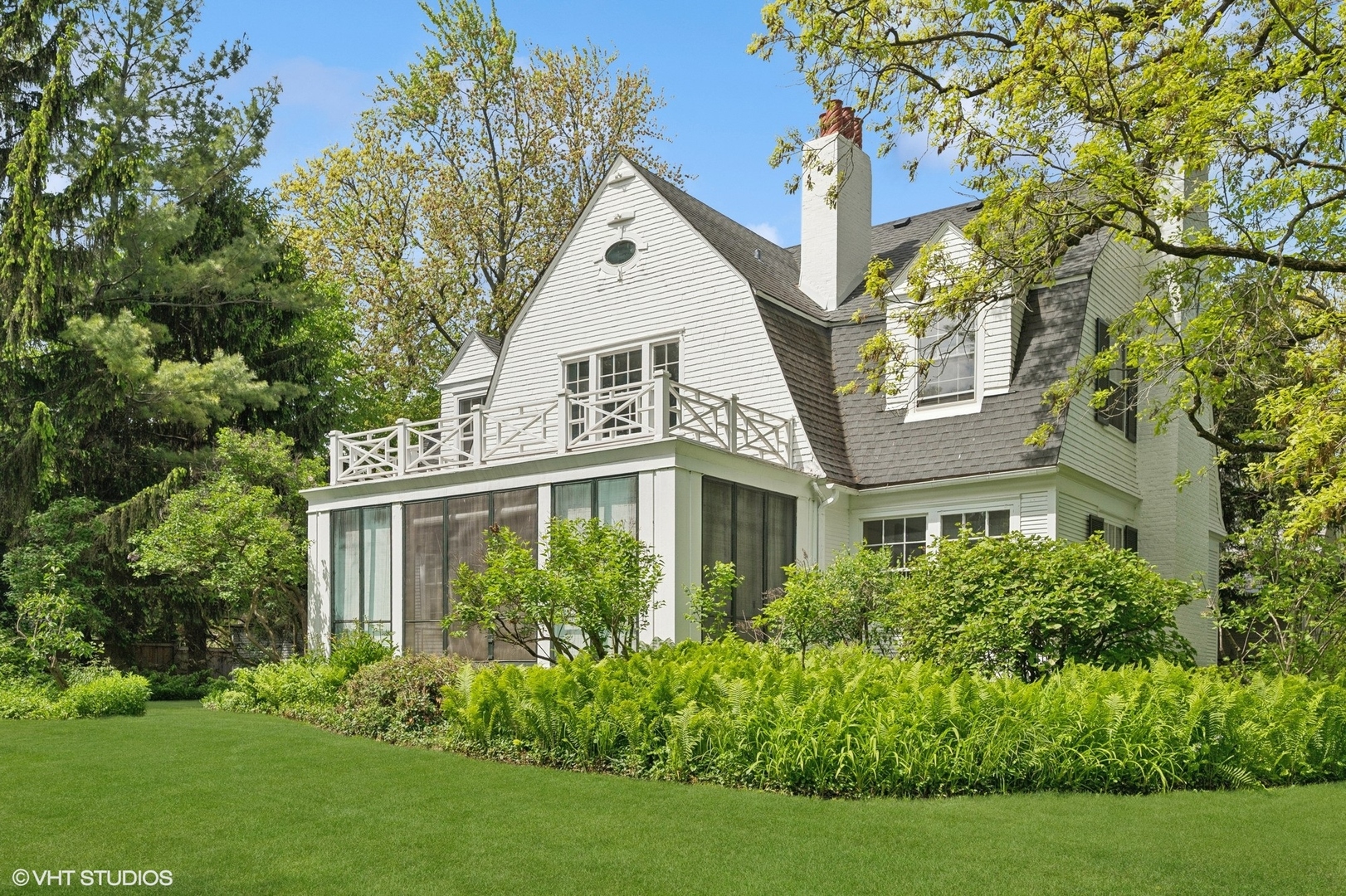 550 Oak Street Winnetka, IL 60093 - Photo 36 of 45 a view of a white house next to a yard with big trees