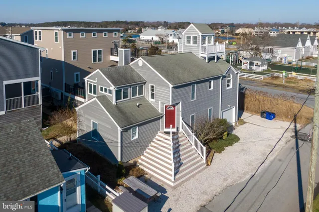 an aerial view of multiple houses with a yard
