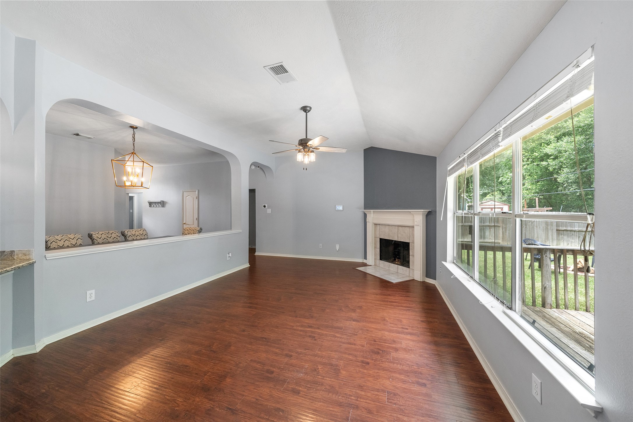 19718 Teller Boulevard Spring, TX 77388 - Photo 11 of 47 a view of a livingroom with wooden floor a fireplace and window