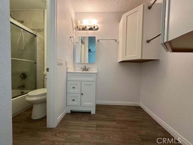 12621 Moordale Circle, Unit H Stanton, CA 90680 - Photo 11 of 17 a bathroom with a toilet sink a vanity and mirror