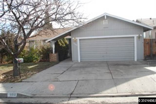 1950 Stardust Street Reno, NV 89503 - Photo 1 of 6 a front view of a house with garage