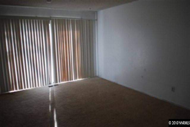 1950 Stardust Street Reno, NV 89503 - Photo 3 of 6 a view of a empty room with a window