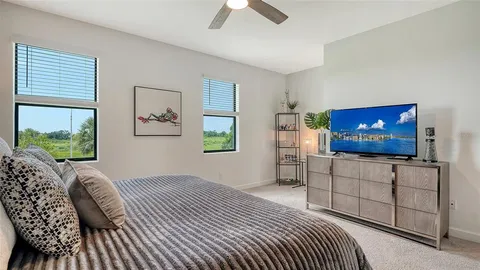 a bedroom with furniture and a flat screen tv