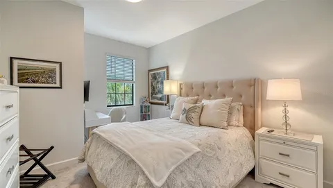 a bedroom with a bed and a night stand