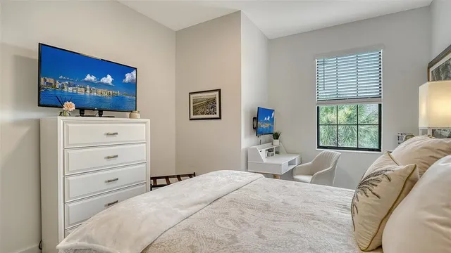 a bedroom with a bed and a television