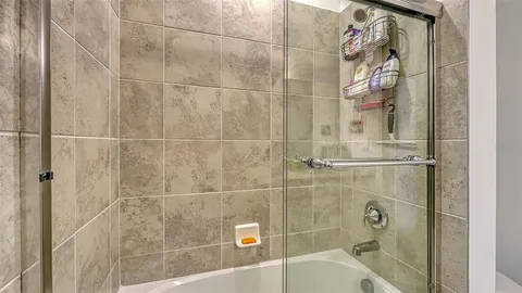 a bathroom with a bathtub and shower