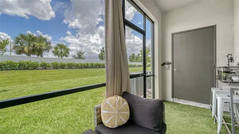 a living room with hardwood floor and a floor to ceiling window