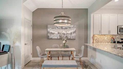 a dining room with furniture and window