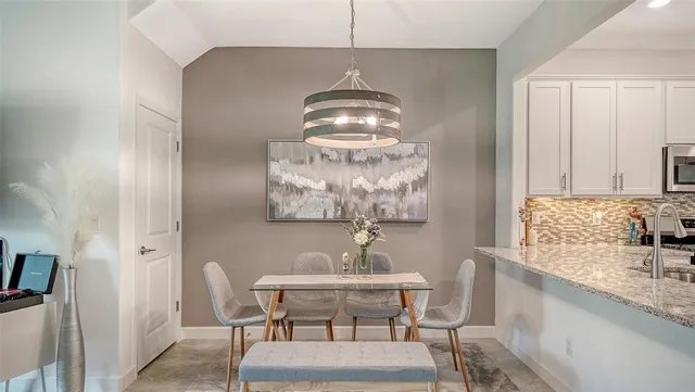 a dining room with furniture and window