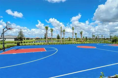 a view of a playground with basketball court