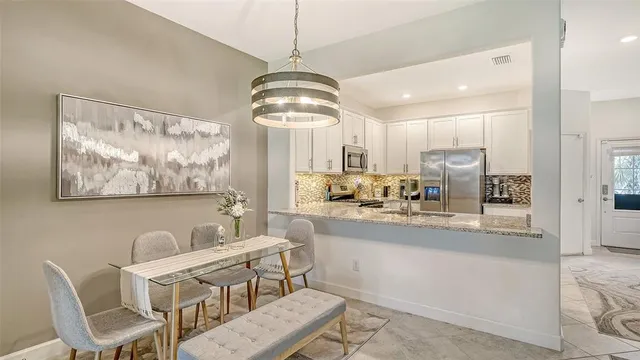 a view of dining room and kitchen with a chandelier