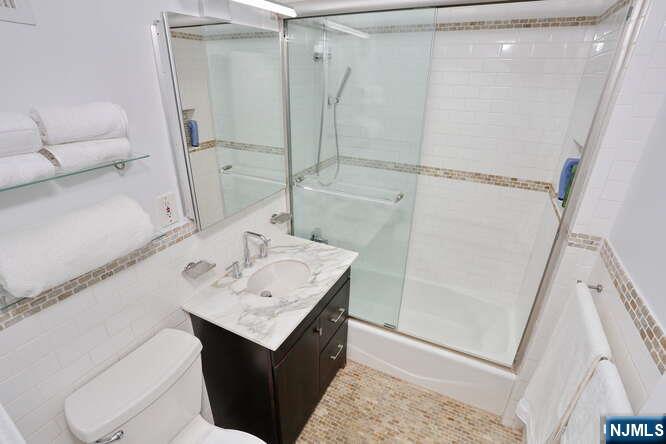 4 Horizon Road, Unit 1027 Fort Lee, NJ 07024 - Photo 22 of 38 a bathroom with a sink a mirror and a shower