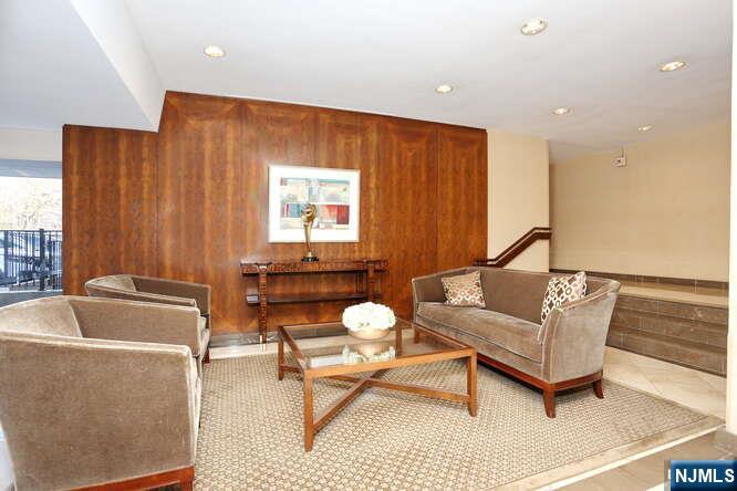 4 Horizon Road, Unit 1027 Fort Lee, NJ 07024 - Photo 36 of 38 a living room with furniture a rug and a window