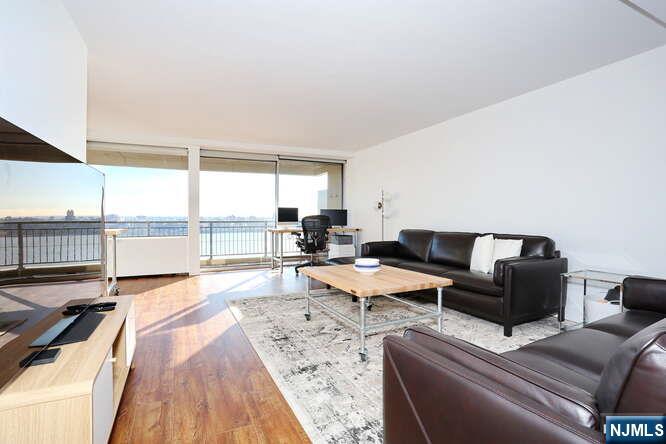 4 Horizon Road, Unit 1027 Fort Lee, NJ 07024 - Photo 6 of 38 a living room with furniture and a large window