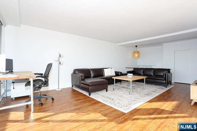 4 Horizon Road, Unit 1027 Fort Lee, NJ 07024 - Photo 8 of 38 a living room with furniture a rug and a table