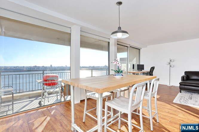 4 Horizon Road, Unit 1027 Fort Lee, NJ 07024 - Photo 10 of 38 a dining room with furniture a chandelier and a rug