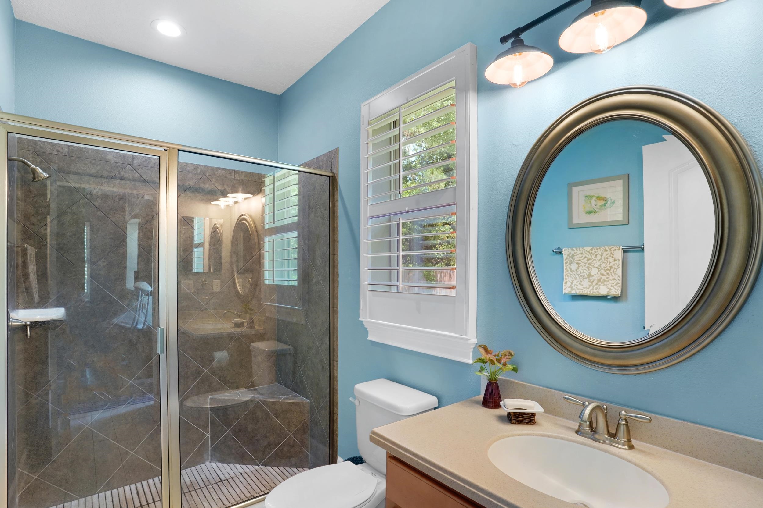 1308 Acorn Ridge Court St. Augustine, FL 32092 - Photo 28 of 47 a bathroom with a sink a mirror a toilet and a shower