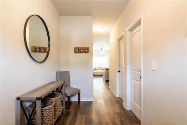 a view of a hallway with wooden floor and entryway